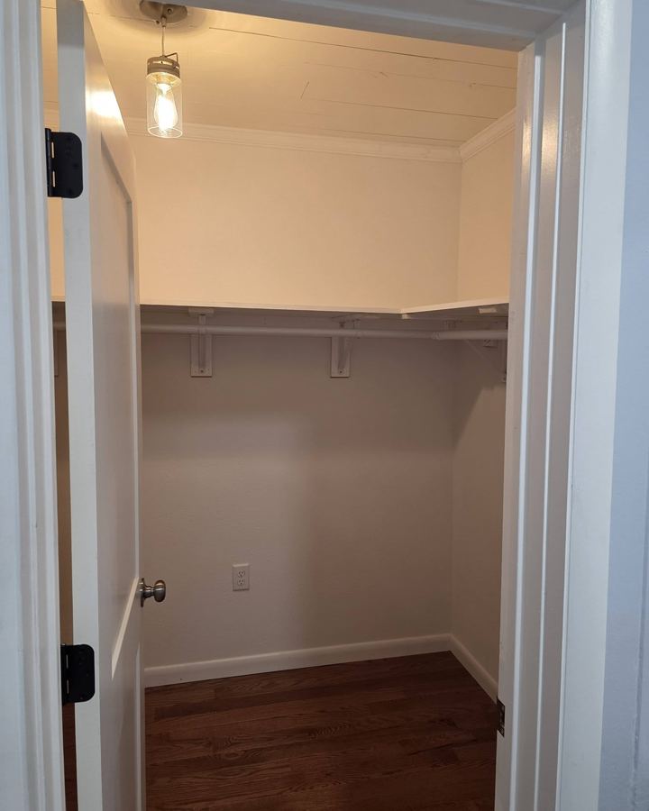Closet with a new shelf and rod, crown molding, and painted casing