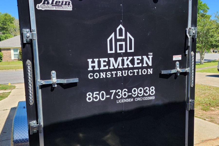 Back of the Hemken Construction trailer with the logo, phone number, and license number