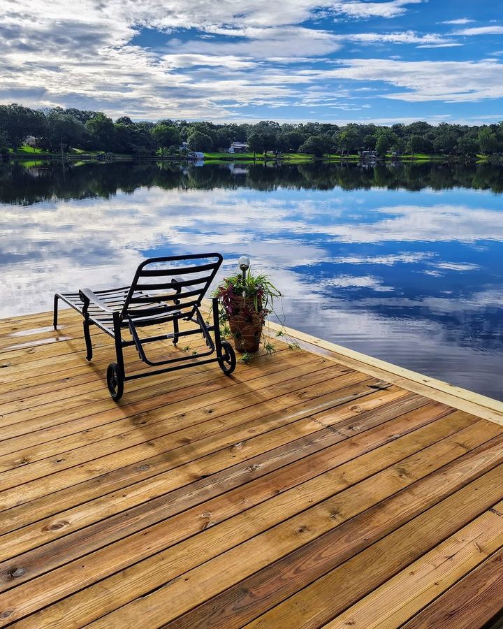 Close view of the dock decking boards with a lounge chair, showing tight, even board spacing