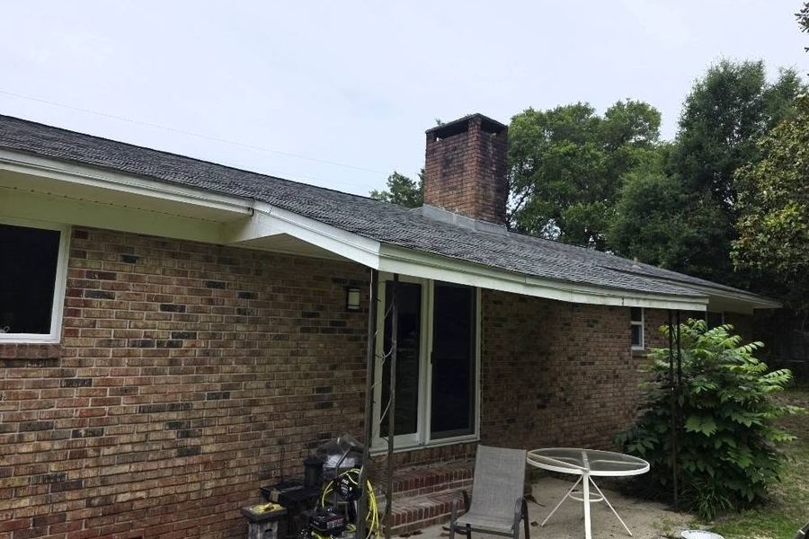 The same back of the house before the deck: concrete pad and a bare wall