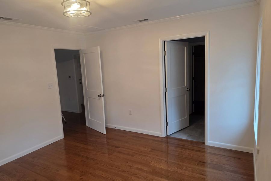 Bedroom with refinished oak hardwood floors and new five-panel doors