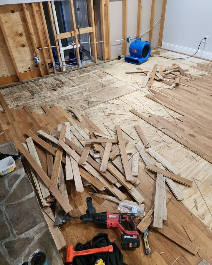 Old flooring removed and subfloor exposed before the new tile goes down