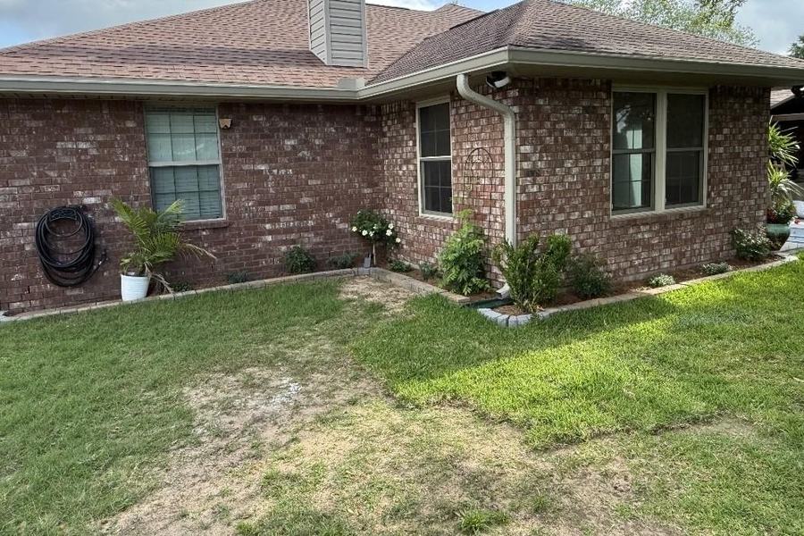 Rear of the house after the patio was enclosed, brick matched to the original and new windows set