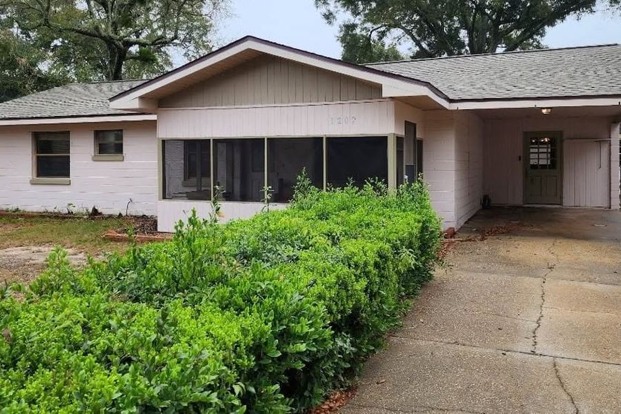 House before the exterior remodel: screened porch, carport, and worn finishes
