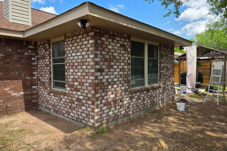 New exterior door and window set into brick that matches the original house